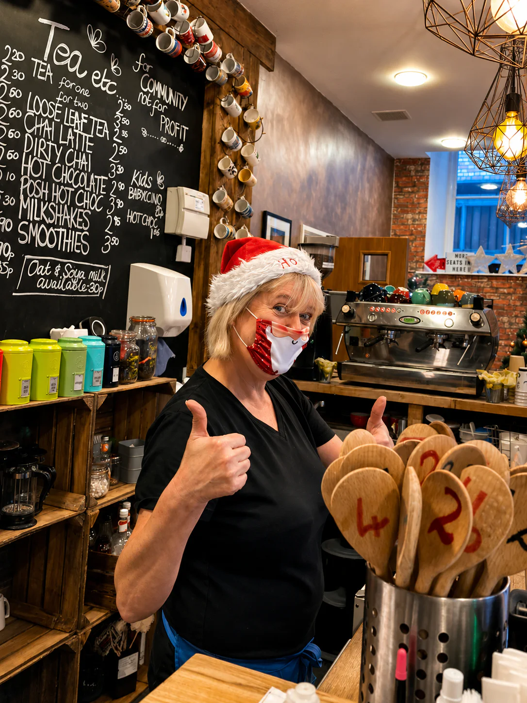 A Palmer's team member giving a thumbs up behind the coffee counter