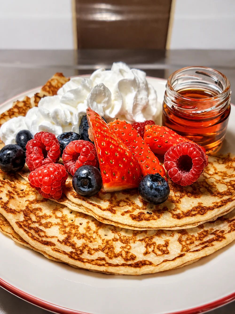 Berry-topped pancakes with cream and syrup at Palmer's